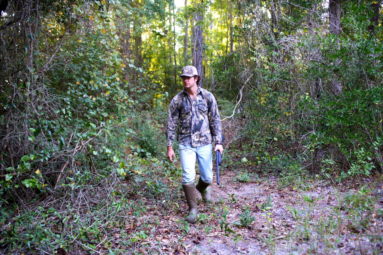 Tanner walking through thick green brush