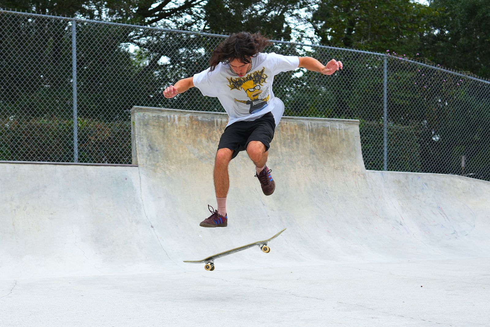 Jaden in the air with the board flipping beneath his feet