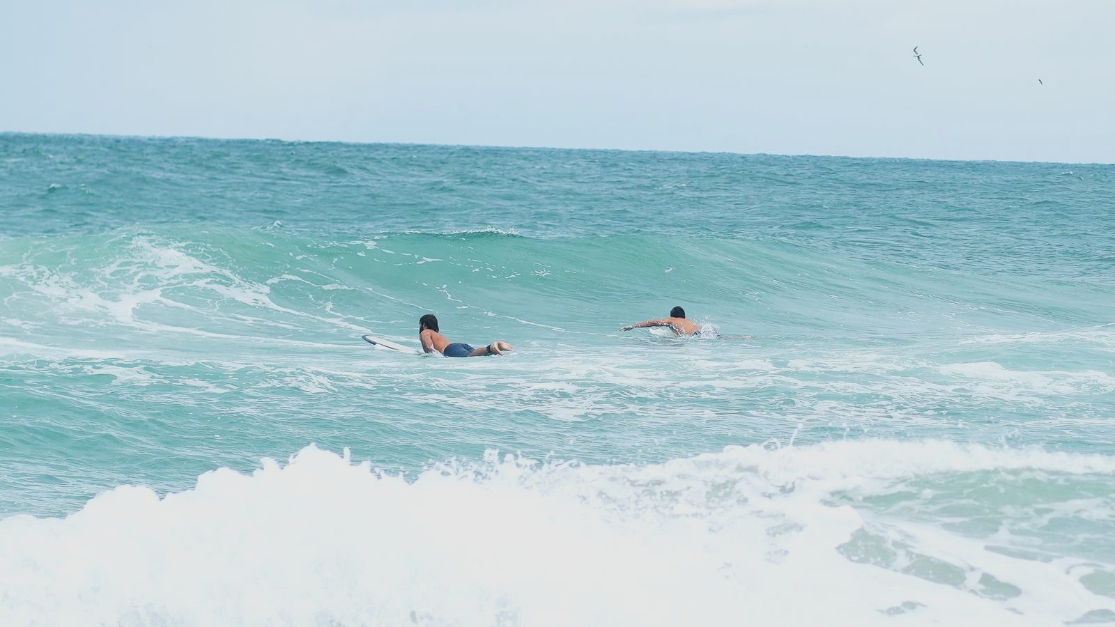 Turner and Shepp paddling out together through the inside