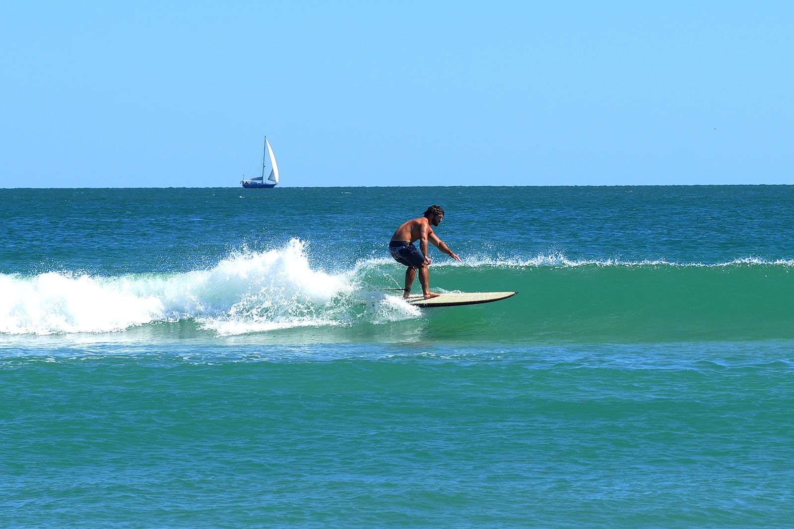 Turner setting up on the face of a green wave